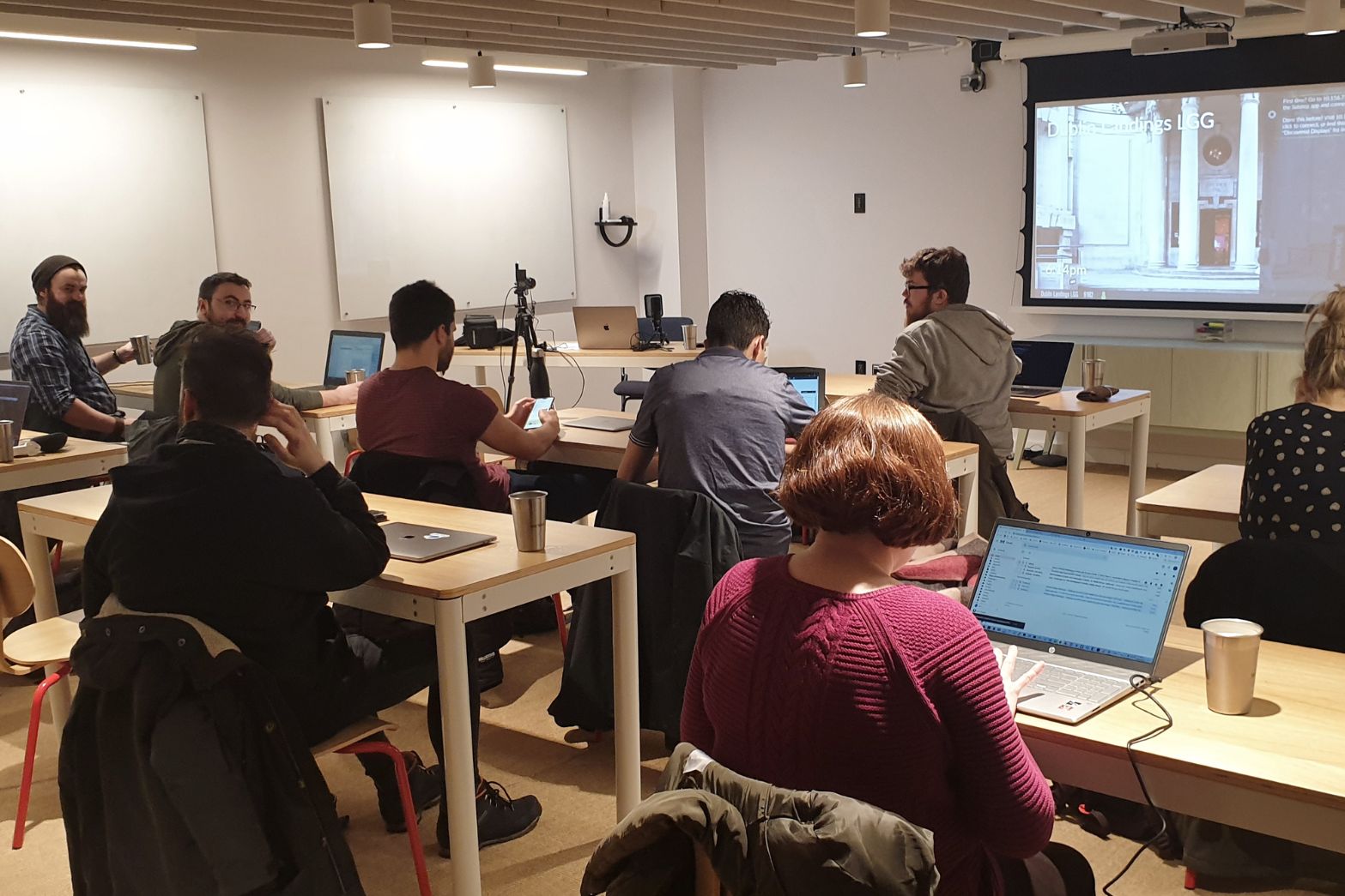 Developers working on their laptops at a table